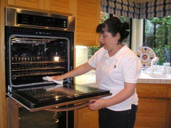 Martha Nava cleaning an oven